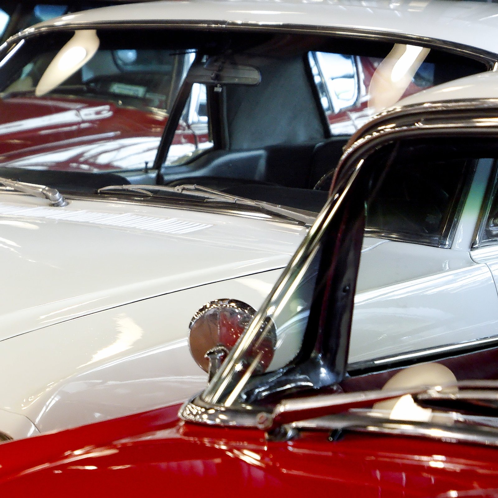 Closeup of retro cars pained in red and white. Details of automobiles
